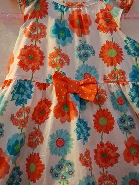 White Dress with Coral and Turquoise Floral Print Adding A Bloomer As Style.